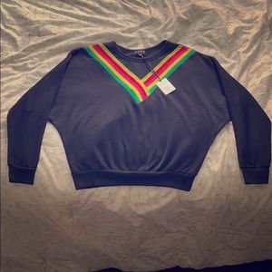 A black POOF sweater with colorful stripes.